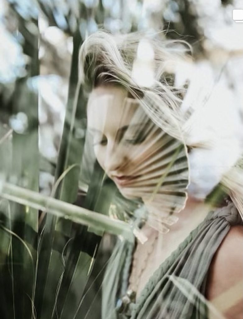 double exposure woman in green dress with ferns